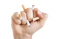 ManÃ¢â¬â¢s hand crushing cigarettes Royalty Free Stock Photo